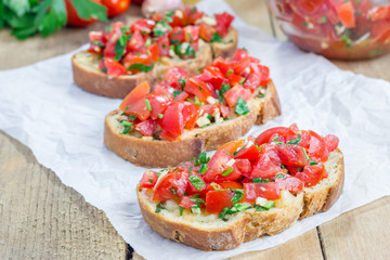 Bruschetta with tomatoes, herbs and oil on toasted garlic cheese bread
