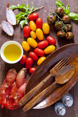 ingredients for a salad.Wooden oval plate. Wooden spoon and fork