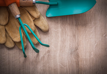 Leather working gloves gardening trowel and rake on wood board h