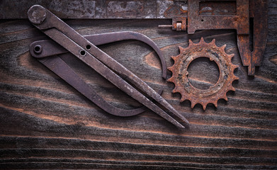 Rusty obsolete measuring calipers with gear wheel on vintage dar