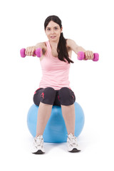 girl lifting weights in gym ball