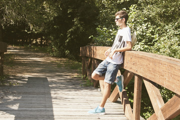 young boy waiting leaning outdoors