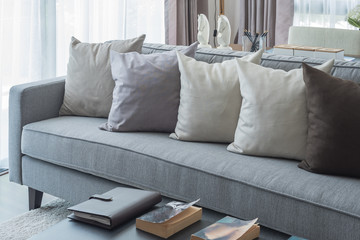 row of pillows on modern grey sofa