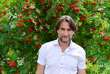 man stands near the rowan