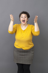 surprise and success concept - cheerful big young woman expressing herself with both hands,laughing for surprise and happiness