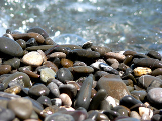 Stones on background of sea water with reflections