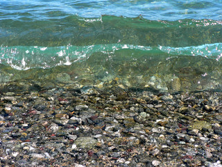 Stones on background of sea water with reflections