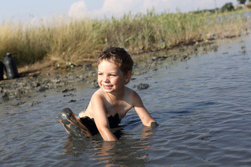 Boy applying healthy mud