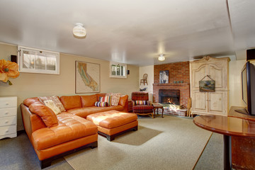 Secondary living room with orange couch.