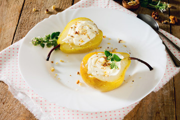 Delicious dessert with pears, sliced halves and curd cream on a