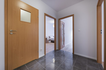 Bedrooms in modern apartment - view from corridor