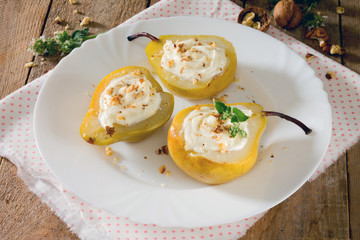 Delicious dessert with pears, sliced halves and curd cream on a