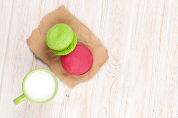 Colorful macarons and cup of milk