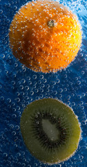 kiwi and tangerine in carbonated water