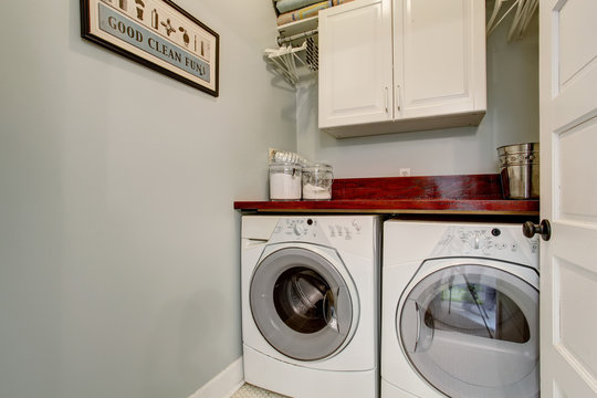 Small Laundry Room With Door And Washr Dryer Set.