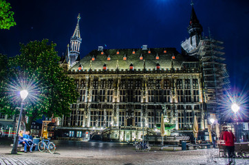 night ivew of the illuminated town hall in german city aachen.