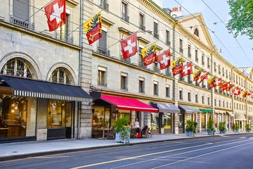 Foto op Plexiglas Geneva city street Rue Carraterie  view in summer with swiss flags on the street © Roman Babakin