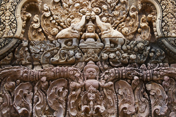 Fototapeta na wymiar Detail of decoration in Banteay Srei showing elephants and a figure of the Buddha.near Seim Reap, Cambodia