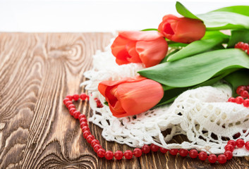 red tulips on wooden background