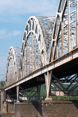 Arched steel bridge against blue sky
