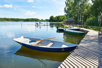 Naklejka premium Landscape with pier of pleasure boats on Lake Valdai
