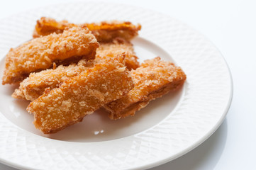Fried fish nuggets on white background