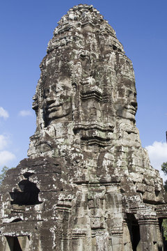 Tower with carved stone faces at the Bayon, 1100's buddhist temple.near Seim Reap,Cambodia.