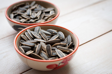 Close up sunflower seed in ceramic dish isolated on white