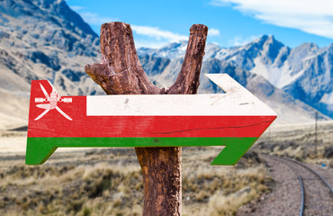 Oman Flag wooden sign with mountains background