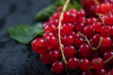Fresh ripe redcurrant fruit on slate background
