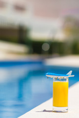 Summer and traveling concept: small airplane model and glass of