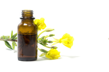 evening primrose oil, flowers and a bottle, isolated on white