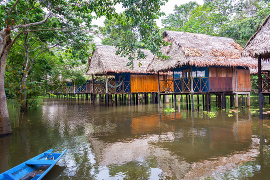 Bungalows in the Amazon rain forest in a flooded area on stilts near Iquitos, Peru
