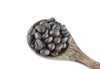 Coffee beans in wooden spoon isolated on white.