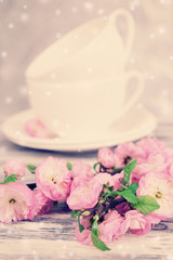 Beautiful fruit blossom and tea cups on table