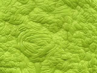 Bright green polymer mass with a gloss flat, dough or mud like structure in green shades