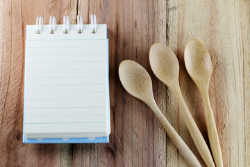 Notebook and wooden spoon.