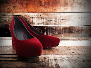 Red woman shoes isolated on old wood