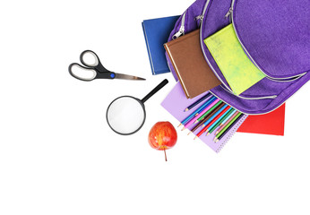 Books, apple, loupe, backpack and pencils isolated on white back