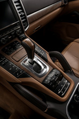 Luxury automatic car transmission control buttons and gear lever. Interior detail.