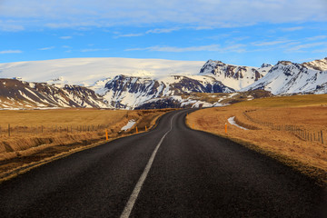 Road leading to snow covered mountains