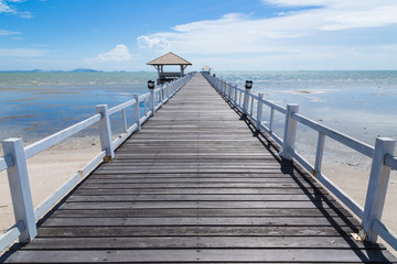 The wooden bridge walkway jutting into the sea.