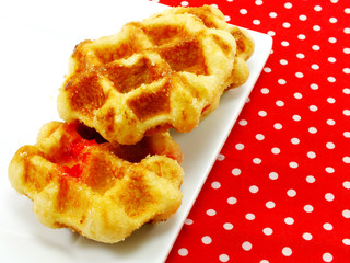 homemade sweet waffles with chocolate and strawberry sauce