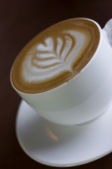 Cup of art latte or cappuccino coffee.