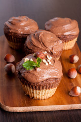 Chocolate muffins with nuts, decorated with mint
