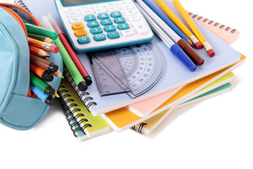 Student school supplies equipment calculator pencil case books writing notebook pens pencils pile heap isolated on white background photo
