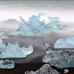 black lava sand with icebergs from glaciers
