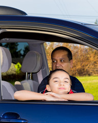 Father And Daughter Sitting In Mini Van