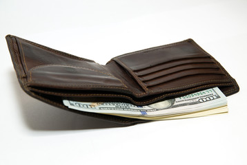Old wallet with banknotes of US dollars inside
