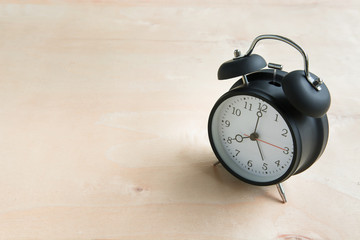 Alarm clock isolated on wooden floor